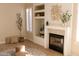 Living room with a modern fireplace, built-in shelving, and stylish decor at 17911 N Adobe Mesa Ct, Surprise, AZ 85374