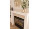 Close up of a modern fireplace with tile surround and decorative mantel at 17911 N Adobe Mesa Ct, Surprise, AZ 85374