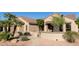 Charming single-story home featuring desert landscaping, tiled roof, and inviting gated entrance at 17911 N Adobe Mesa Ct, Surprise, AZ 85374