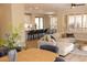 An open living room features natural light, a large sofa and access to the kitchen, creating a cohesive and welcoming space at 17911 N Adobe Mesa Ct, Surprise, AZ 85374
