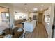 Bright open-concept living room shows kitchen, dining and living areas with views to backyard through sliding glass door at 17911 N Adobe Mesa Ct, Surprise, AZ 85374