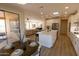 Open concept living space with kitchen, dining area, and access to outdoor patio at 17911 N Adobe Mesa Ct, Surprise, AZ 85374