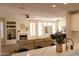 Open concept living area with a modern kitchen, dining area, and comfortable sofa at 17911 N Adobe Mesa Ct, Surprise, AZ 85374