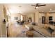 Open living space with a cozy sofa, fireplace, dining area, and modern kitchen at 17911 N Adobe Mesa Ct, Surprise, AZ 85374
