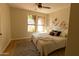 Cozy main bedroom with bright windows, ceiling fan, and neutral walls at 17911 N Adobe Mesa Ct, Surprise, AZ 85374
