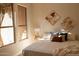 Bright and airy main bedroom with large windows offering natural light, and wood flooring at 17911 N Adobe Mesa Ct, Surprise, AZ 85374