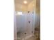 Luxurious walk-in shower with glass enclosure, rain shower head, built-in bench, and stylish tile design at 17911 N Adobe Mesa Ct, Surprise, AZ 85374