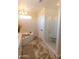 Luxurious walk-in shower with glass enclosure, rain shower head, built-in bench, and stylish tile design at 17911 N Adobe Mesa Ct, Surprise, AZ 85374