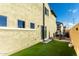 Backyard featuring a patio, an outdoor dining set, and artificial grass at 17970 N 114Th Ln, Surprise, AZ 85378