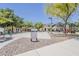 Community basketball court and playground area with surrounding green space, providing recreational opportunities for residents at 17970 N 114Th Ln, Surprise, AZ 85378
