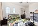 Comfortable bedroom with carpeted floors, neutral walls, and arched windows for natural light at 17970 N 114Th Ln, Surprise, AZ 85378