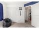 Bedroom with a cozy seating area, a closet, and an open doorway at 17970 N 114Th Ln, Surprise, AZ 85378