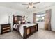 Cozy bedroom with stylish furniture, neutral paint, soft carpet, and a ceiling fan at 17970 N 114Th Ln, Surprise, AZ 85378