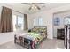 Bright bedroom with arched windows, a ceiling fan, and carpeted floors at 17970 N 114Th Ln, Surprise, AZ 85378