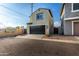 Exterior shot of a two-story home featuring a dark garage door, tile roof, and low maintenance desert landscape at 17970 N 114Th Ln, Surprise, AZ 85378