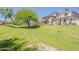 Scenic greenbelt area with lush grass and mature trees near attractive townhomes, enhancing community living at 17970 N 114Th Ln, Surprise, AZ 85378
