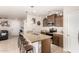 Modern kitchen with granite countertops, stainless steel appliances, and barstool seating at 17970 N 114Th Ln, Surprise, AZ 85378