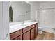 Bathroom featuring a single sink vanity, a tub with shower, and a functional layout at 17985 W Ivy Ln, Surprise, AZ 85388