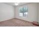 Bright bedroom with large window offering natural light, and neutral wall color at 17985 W Ivy Ln, Surprise, AZ 85388