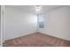 Clean bedroom featuring neutral walls, one window, and carpeted floors at 17985 W Ivy Ln, Surprise, AZ 85388