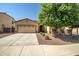 Charming single-Gathering home with a two-car garage, desert landscaping and mature shade tree in the front yard at 17985 W Ivy Ln, Surprise, AZ 85388