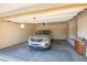 Clean, organized two car garage featuring a vehicle, automatic door, and built in shelving at 17985 W Ivy Ln, Surprise, AZ 85388