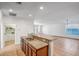 Open kitchen with granite countertops, stainless steel appliances, and a breakfast bar overlooking the living area at 17985 W Ivy Ln, Surprise, AZ 85388