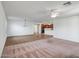 A spacious living room area features a fan and open entry to the kitchen at 17985 W Ivy Ln, Surprise, AZ 85388