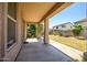 Covered patio with views of the well-maintained backyard and neighboring homes at 17985 W Ivy Ln, Surprise, AZ 85388