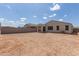 Large, expansive backyard with a block wall, covered patio, and a spacious dirt lot ready for landscaping at 18492 E Donato Dr, Gold Canyon, AZ 85118