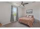 Comfortable bedroom with a ceiling fan, window view, and decorative accents at 18492 E Donato Dr, Gold Canyon, AZ 85118