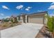 Single-story home with desert landscaping and a two-car garage is shown on a sunny day at 18492 E Donato Dr, Gold Canyon, AZ 85118