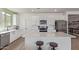 Bright kitchen features white cabinets, stainless steel appliances and a center island with bar stool seating at 18492 E Donato Dr, Gold Canyon, AZ 85118