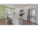 Beautiful kitchen features white cabinets, stainless steel appliances and a large center island with barstool seating at 18492 E Donato Dr, Gold Canyon, AZ 85118