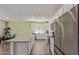 Spacious kitchen with stainless appliances, white cabinets, eat-in island and an adjacent table, perfect for gatherings at 18492 E Donato Dr, Gold Canyon, AZ 85118