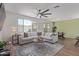Bright and airy living room with a large sectional sofa and a large window with an outdoor view at 18492 E Donato Dr, Gold Canyon, AZ 85118