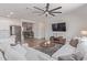 Stylish living room with a gray sectional sofa, large TV, and open access to the kitchen area at 18492 E Donato Dr, Gold Canyon, AZ 85118