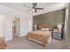 Comfortable main bedroom with a neutral color scheme, ceiling fan, carpet, and access to other rooms at 18492 E Donato Dr, Gold Canyon, AZ 85118