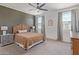 Relaxing main bedroom with a ceiling fan, two windows, soft carpet and stylish furniture at 18492 E Donato Dr, Gold Canyon, AZ 85118