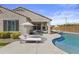 Backyard oasis with a refreshing pool, lounging area, manicured landscaping, and an outdoor seating area at 19203 W Jackson St, Buckeye, AZ 85326