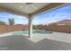 Covered patio overlooking an inviting pool and a well-maintained backyard, perfect for outdoor relaxation and entertainment at 19203 W Jackson St, Buckeye, AZ 85326