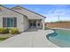 Exterior view of the backyard featuring a refreshing pool, manicured landscaping, and privacy walls at 19203 W Jackson St, Buckeye, AZ 85326