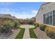 Backyard showcasing a brick walkway and manicured landscaping, enclosed by a privacy wall for secluded relaxation at 19203 W Jackson St, Buckeye, AZ 85326