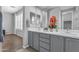 Bright bathroom featuring a double vanity with stylish hardware and plantation shutters at 19203 W Jackson St, Buckeye, AZ 85326