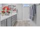 Bright bathroom featuring a double vanity with stylish hardware and a glass enclosed shower at 19203 W Jackson St, Buckeye, AZ 85326