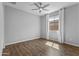 This bedroom offers gorgeous wood floors, a ceiling fan, and a window for natural light at 19203 W Jackson St, Buckeye, AZ 85326