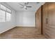 Spacious bedroom with a ceiling fan, neutral walls, hardwood floors, and custom wood built-in storage at 19203 W Jackson St, Buckeye, AZ 85326