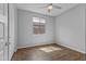 This bedroom offers gorgeous wood floors, a ceiling fan, and a window for natural light at 19203 W Jackson St, Buckeye, AZ 85326