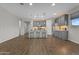 Modern kitchen boasts gray cabinets, stainless steel appliances, and a stylish island with seating at 19203 W Jackson St, Buckeye, AZ 85326