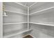 Walk-in pantry features ample shelving for organized storage at 19203 W Jackson St, Buckeye, AZ 85326
